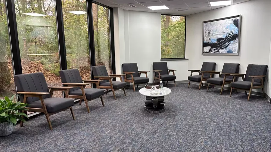 Bright waiting room at Norwell Oral Surgery and Dental Implant Center overlooking the wooded grounds